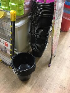 A photo taken inside Woolwich's Wilko with a lot of black buckets on display